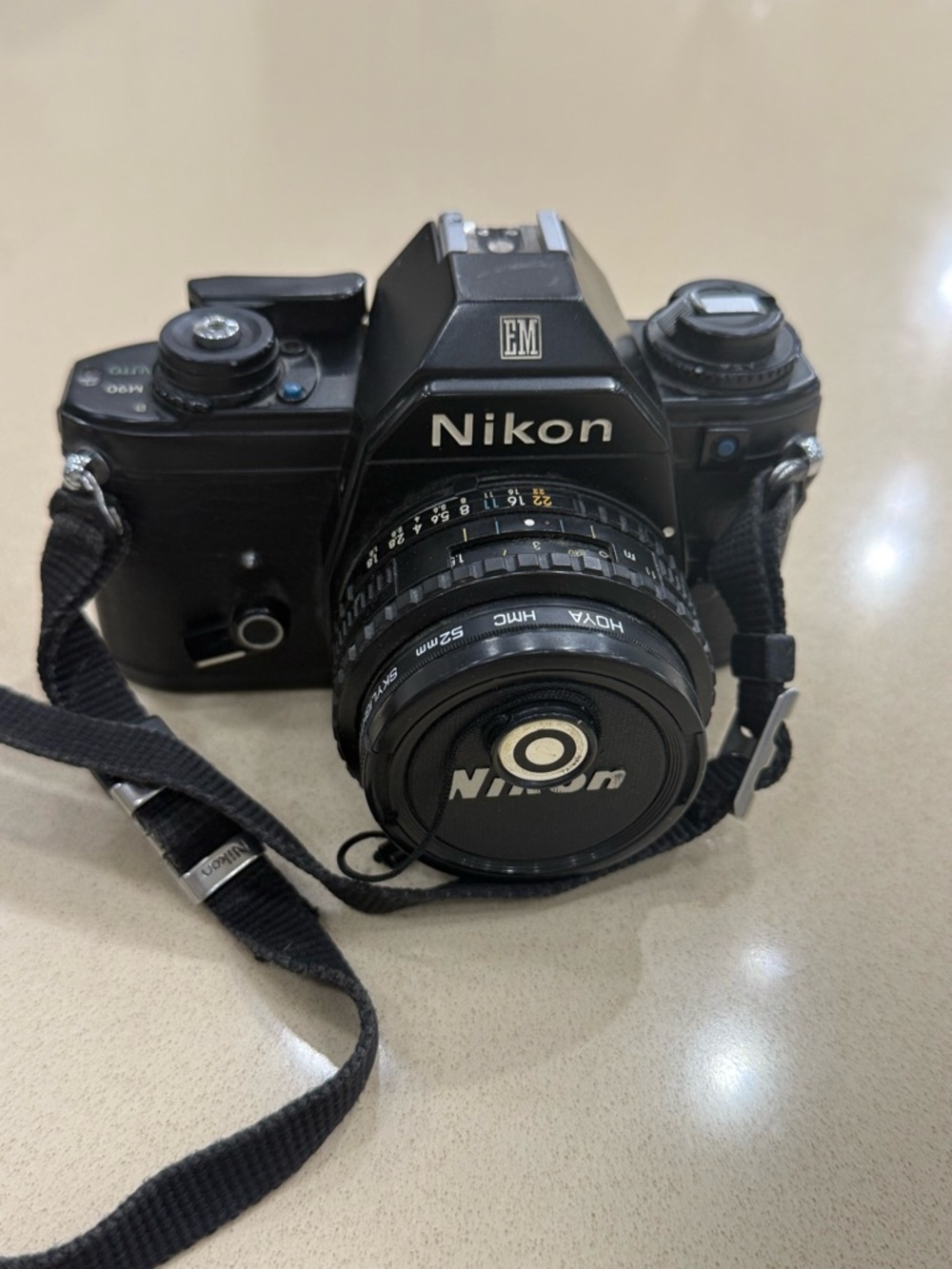 Nikon Black 35mm SLR Camera with Attached Lens and Strap